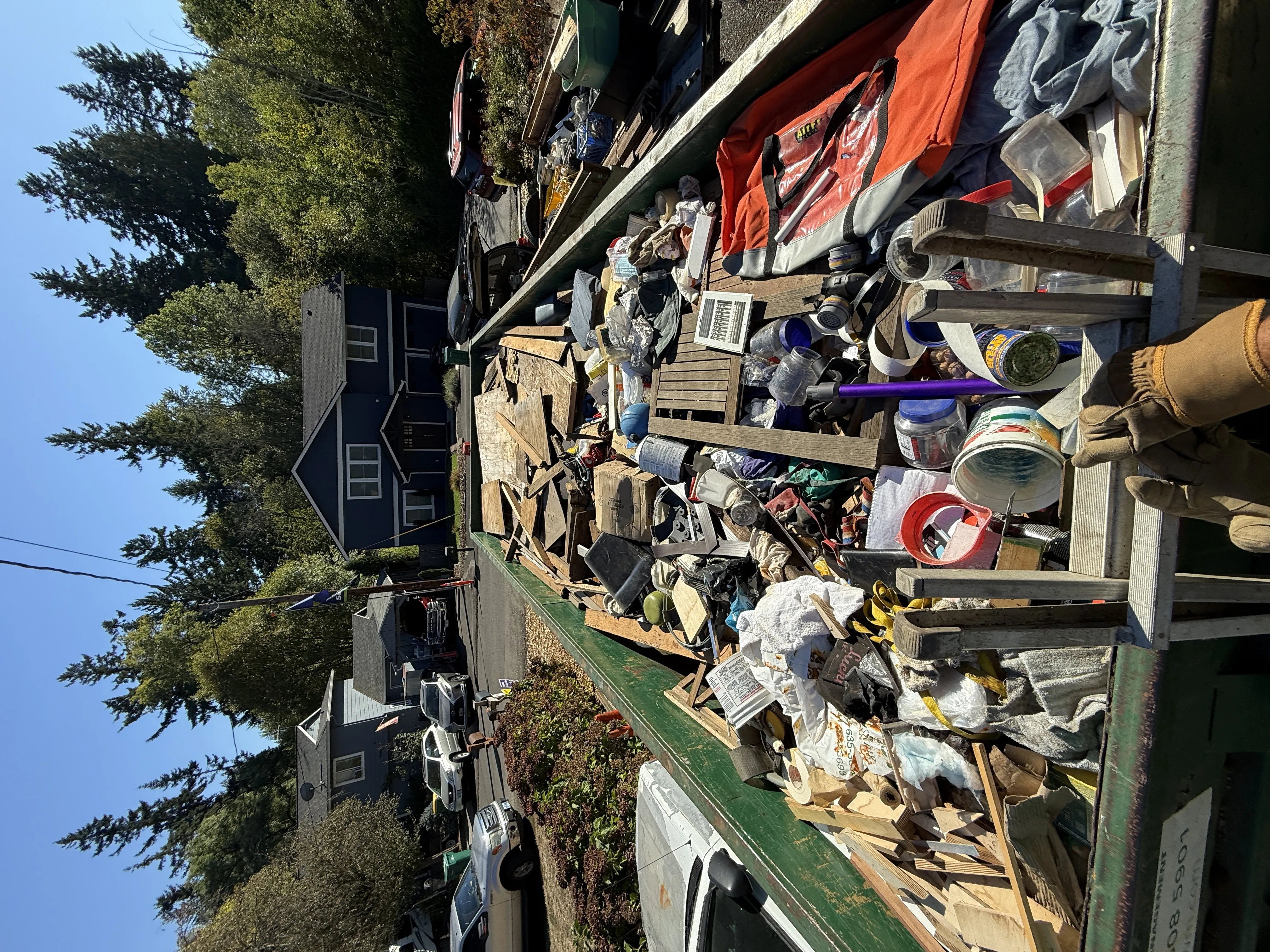 Dumpster full of debris and junk removal materials